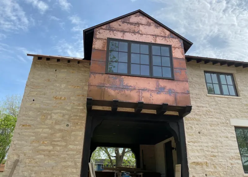 Copper metal panel facade on a stone building for Skylight Installation in Sugarland Run