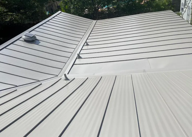 Solar attic fan installed on a metal roof for Roof Ventilation in Sugarland Run